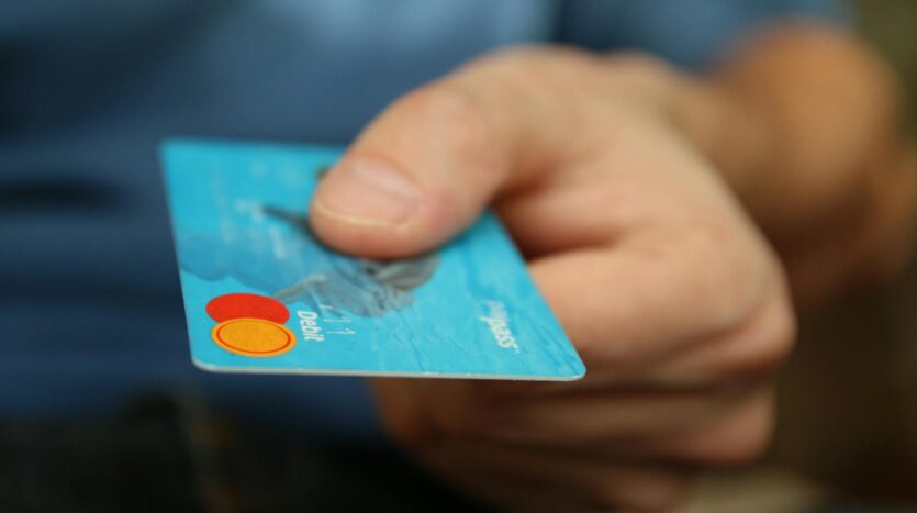 person holding debit card